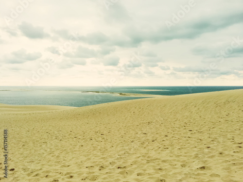 Sand dunes  sea and cloudy sky