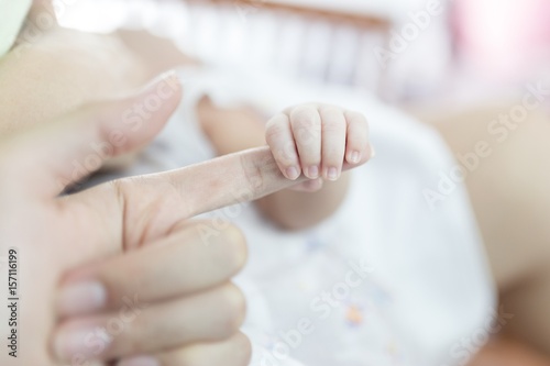 newborn baby hand in bed