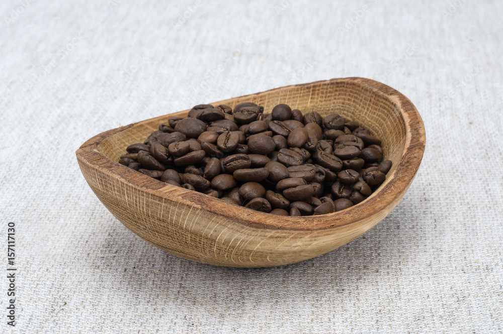 Fototapeta premium Natural coffee beans on a wooden board. 