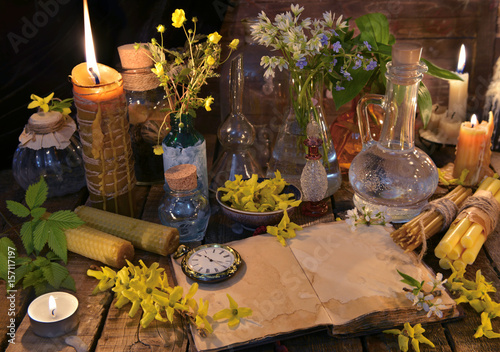 Alternative medicine still life with book  candles and healing herbs.