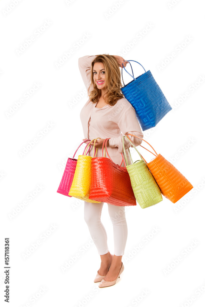 Happy woman posing with bright wicker tote bags.Isolated on the white studio background