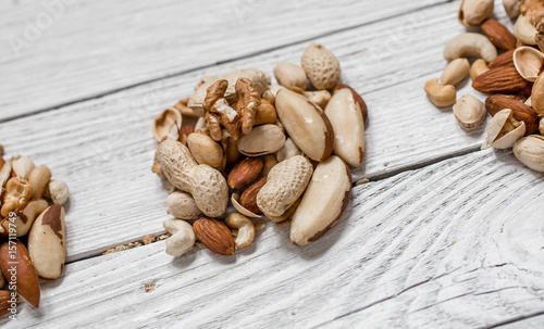different nuts on white wooden background ,