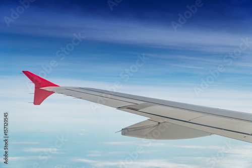 Wing of the plane on blue sky background