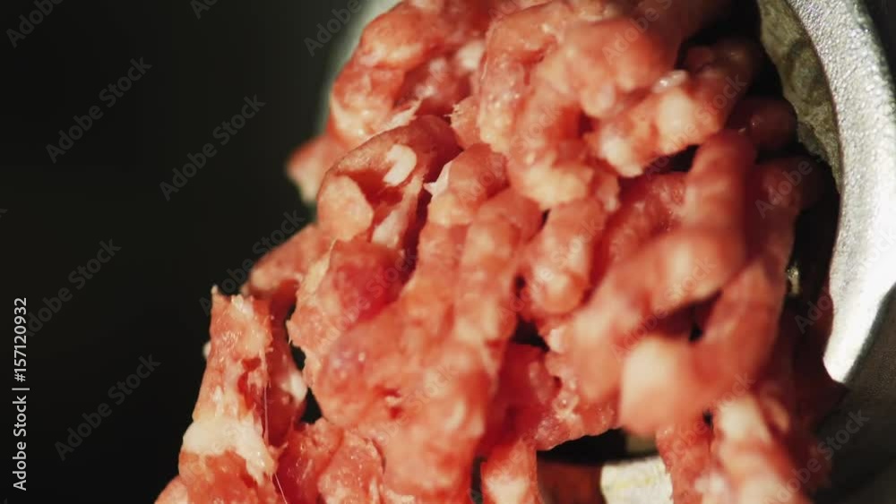 Action of mincer machine with fresh chopped meat. Close-up Action of mincer machine with fresh chopped meat. Close-up