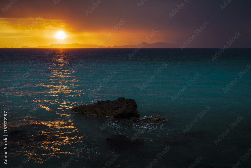 
Sunset seen from the shore of the ocean