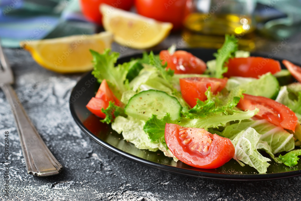 Vegetable salad with cucumber, tomatoes and olive oil on a concrete background Vegetable salad with cucumber, tomatoes and olive oil on a concrete background