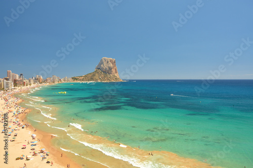 Colorful Mediterranean seascape. People on the beach. Mountain Penyal d'Ifach. Calpe beach, Spain.