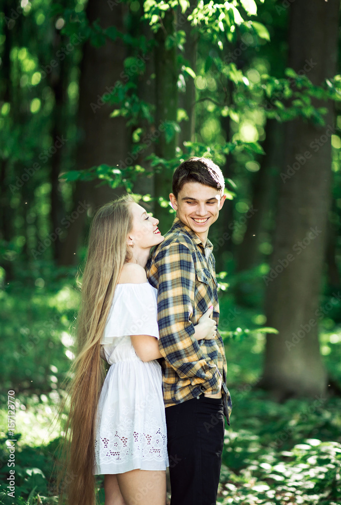Beautiful young couple hugging each other tightly laughing and looking at each other Beautiful young couple hugging each other tightly laughing and looking at each other