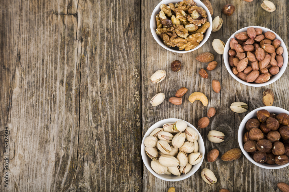 Nuts in a plate on a wooden table. Nuts in a plate on a wooden table.