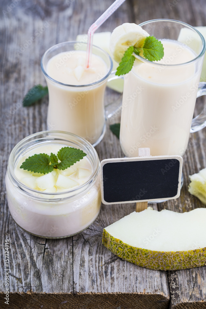 Yogurt and smoothie with melon on a wooden table. Yogurt and smoothie with melon on a wooden table.