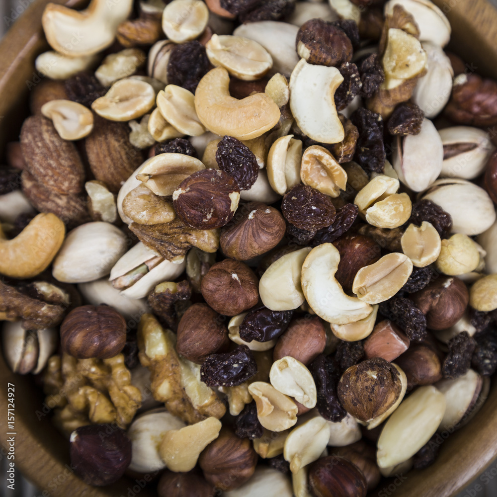 Nuts in a wooden bowl on a wooden table. Nuts in a wooden bowl on a wooden table.