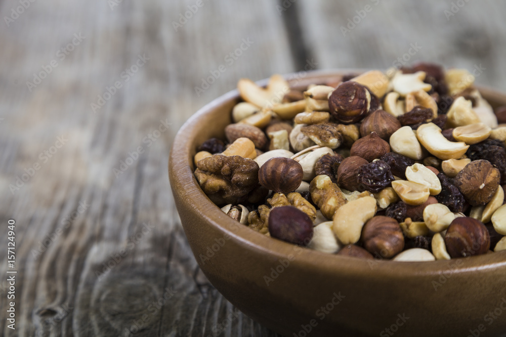 Nuts in a wooden bowl on a wooden table. Nuts in a wooden bowl on a wooden table.