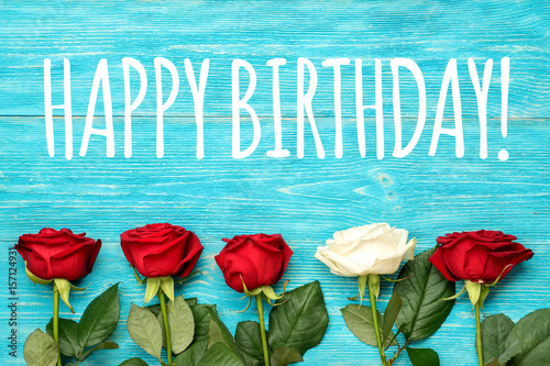Photography happy birthday greeting text on craft paper card with red roses and copy space