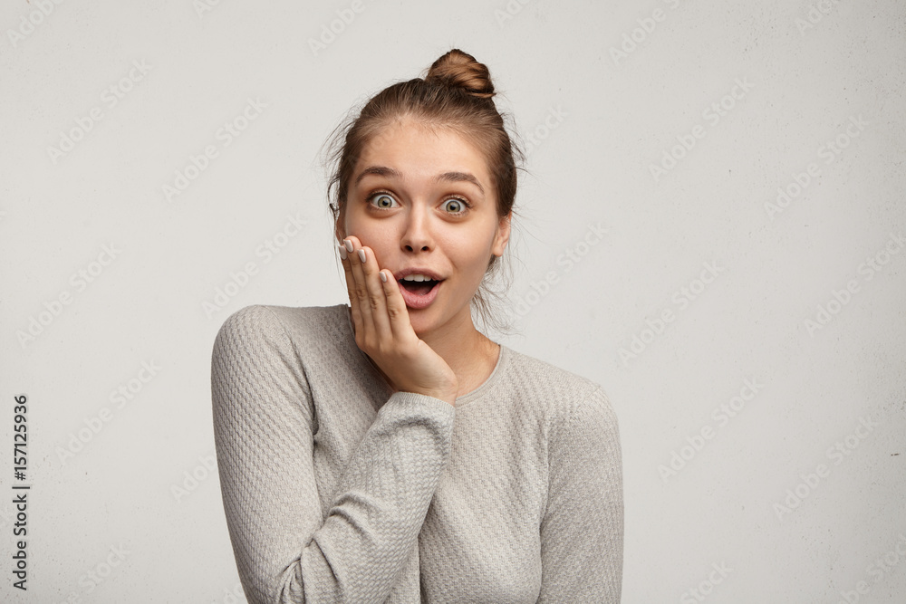 Human emotions, reaction and attitude. Beautiful fascinated young female  dressed casually touching her cheek and exclaiming with delight, having  surprised stunned facial expression, looking at camera Stock-Foto | Adobe  Stock
