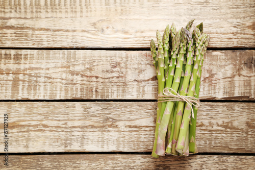 Bunch of green asparagus on grey wooden table