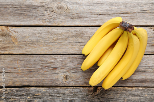 Sweet bananas on grey wooden table