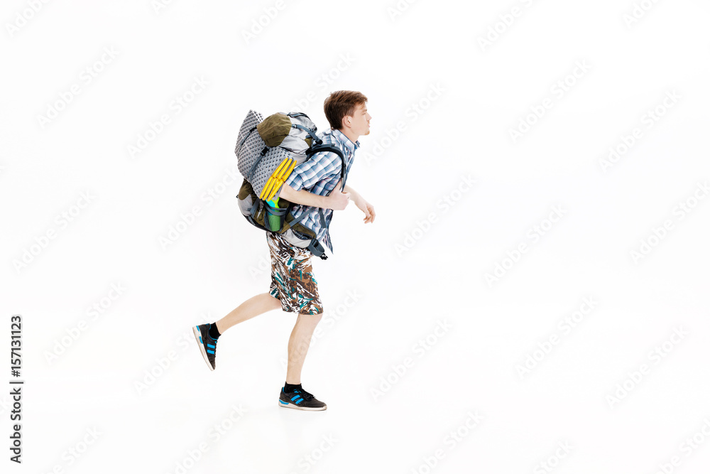 Young tourist with backpack running on white background. hiker was late Young tourist with backpack running on white background. hiker was late