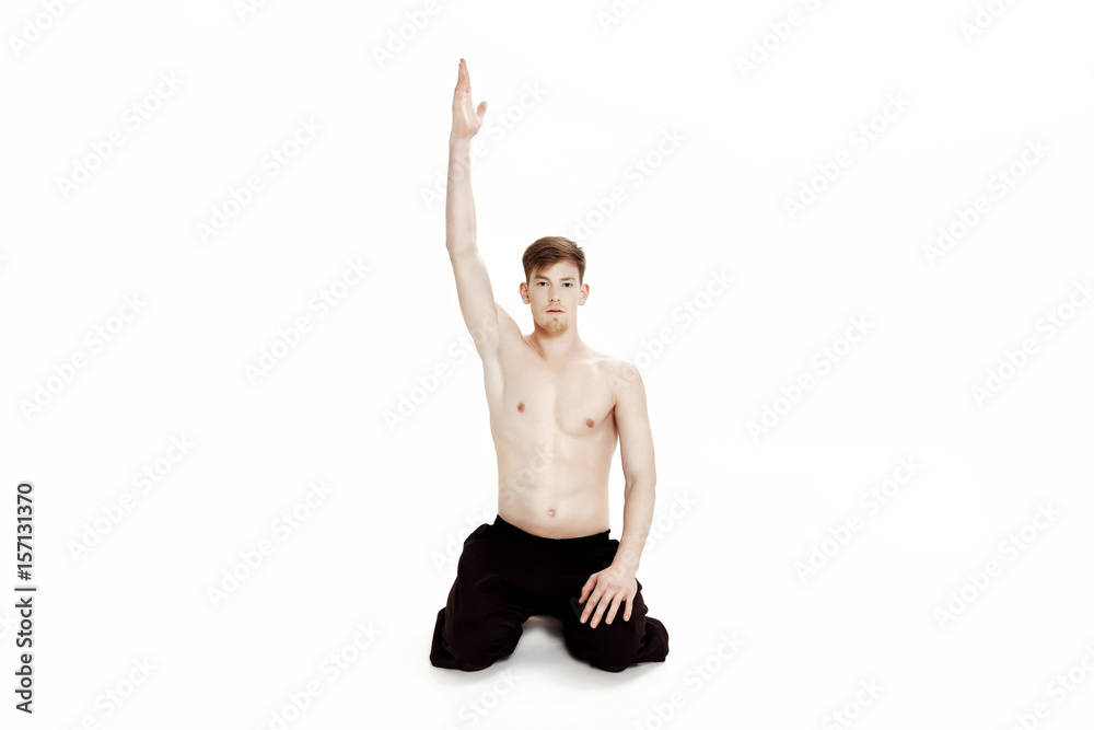 Young man doing yoga exercises. Studio shot on white background Young man doing yoga exercises. Studio shot on white background