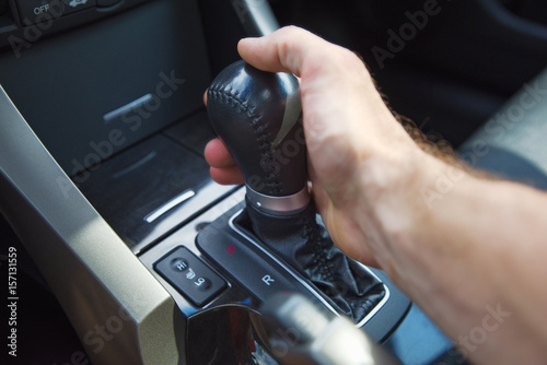A man's hand on an automatic gearbox. Automatic shift transmission.