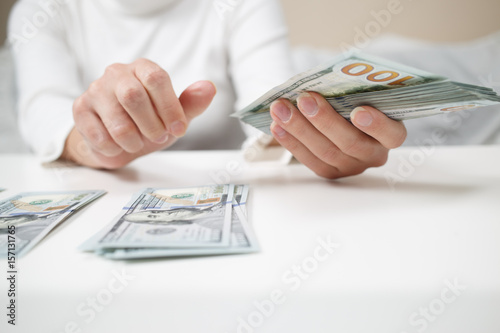 Close up of woman with calculator counting money