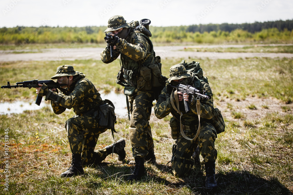 A group of special forces in a field with weapons