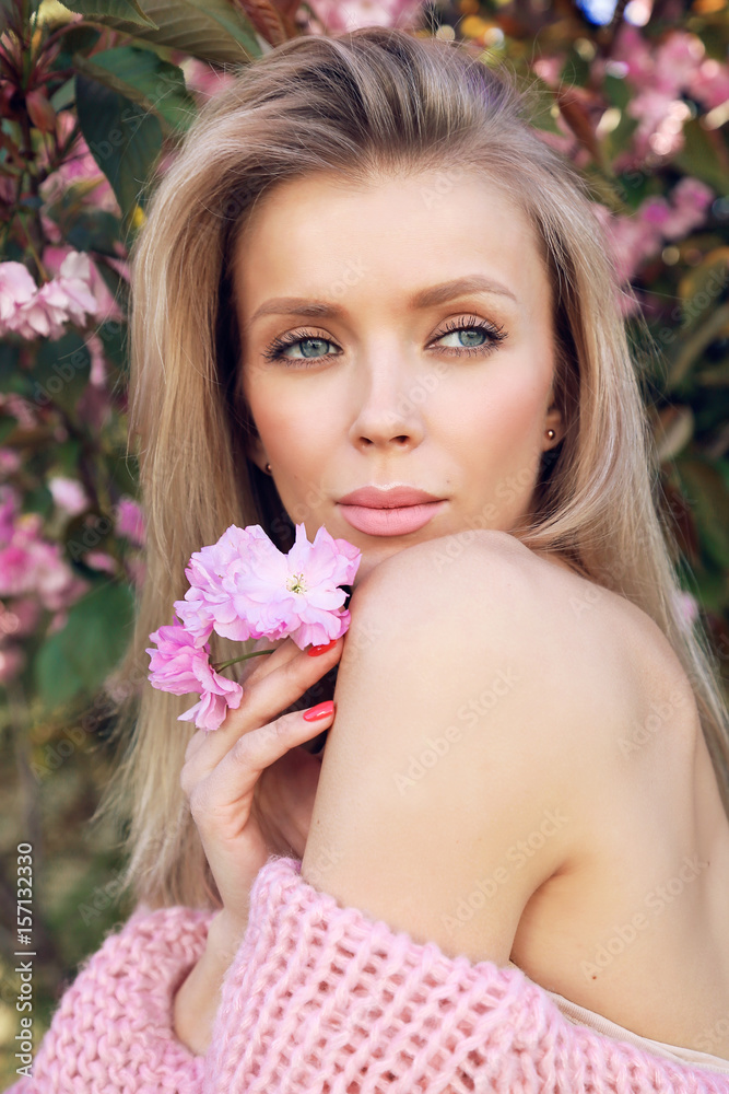 beautiful sexy woman with blond hair posing in summer blossom garden beautiful sexy woman with blond hair posing in summer blossom garden