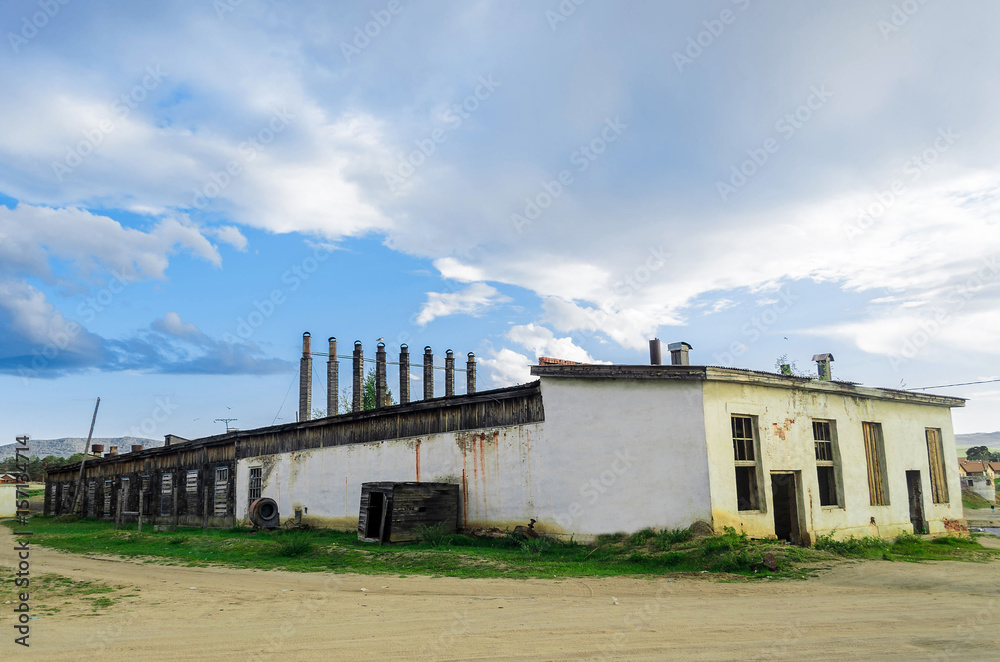 Abandoned one-storey industrial building in the village