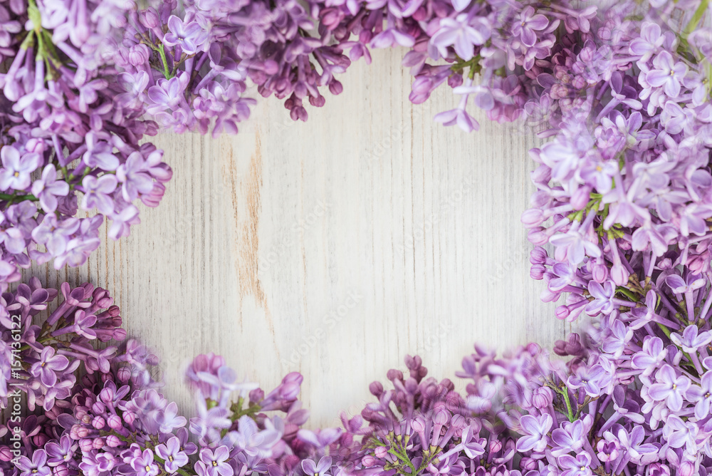 frame of beautiful lilac flowers on light wooden background, selective focus frame of beautiful lilac flowers on light wooden background, selective focus