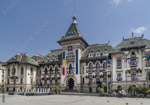 The facade of the Administrative Palace of Craiova (today Dolj Prefecture and County Council), an imposing historical monument located on the territory of Craiova, Romania, on a sunny day