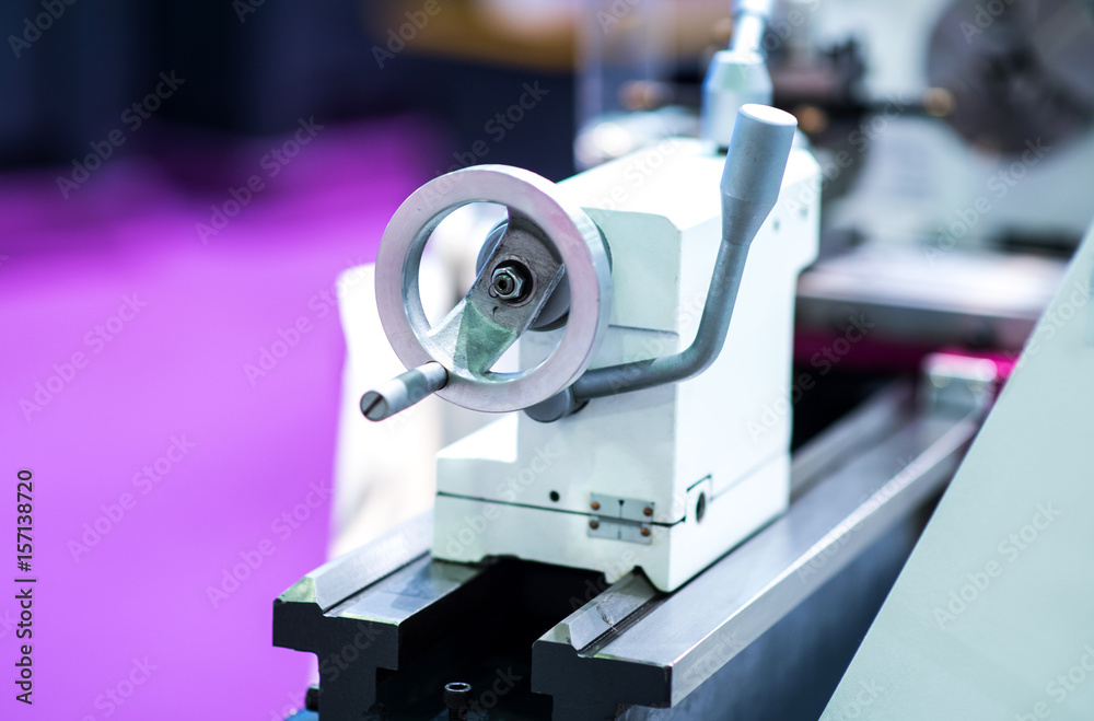 Fototapeta premium Metalworking CNC milling machine. Cutting metal modern processing technology. Small depth of field. Warning - authentic shooting in challenging conditions. A little bit grain and maybe blurred.