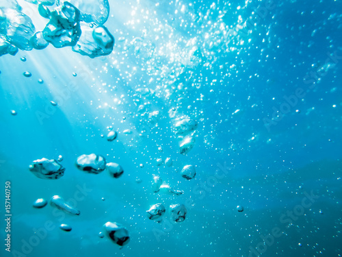 Blue water texture. Bubbles in underwater.