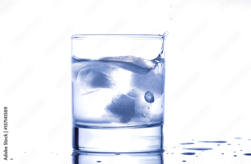 blue water splashing out of a glass with drops blue water splashing out of a glass with drops