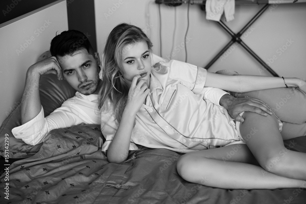 1000px x 667px - Young romantic couple relaxing and hugging in bed. Pretty beautiful blonde  girl and brunette man. Black and white photo. Stock Photo | Adobe Stock