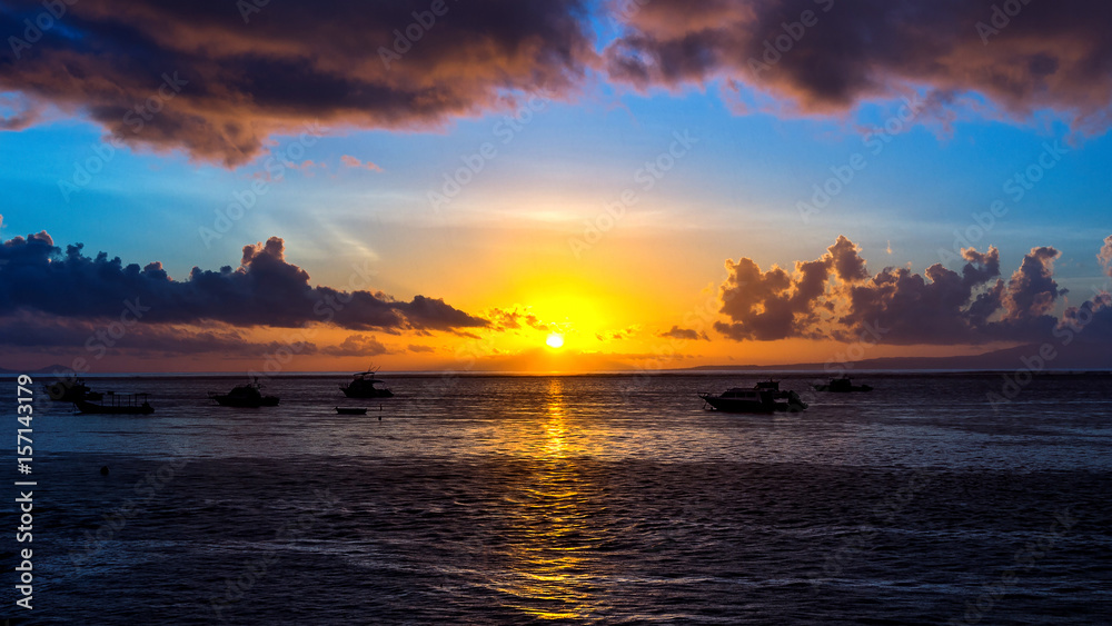 Fishing boat at sunrise in the sea.
