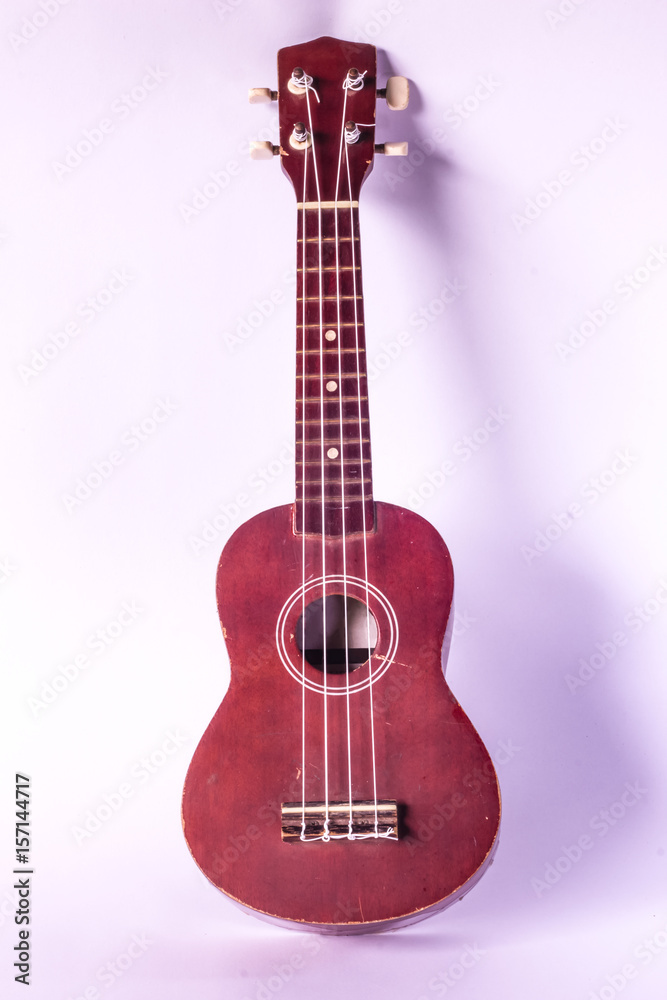 Fototapeta premium old ukulele on white background