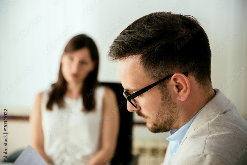 Businessman reading a resume in a job interview Businessman reading a resume in a job interview