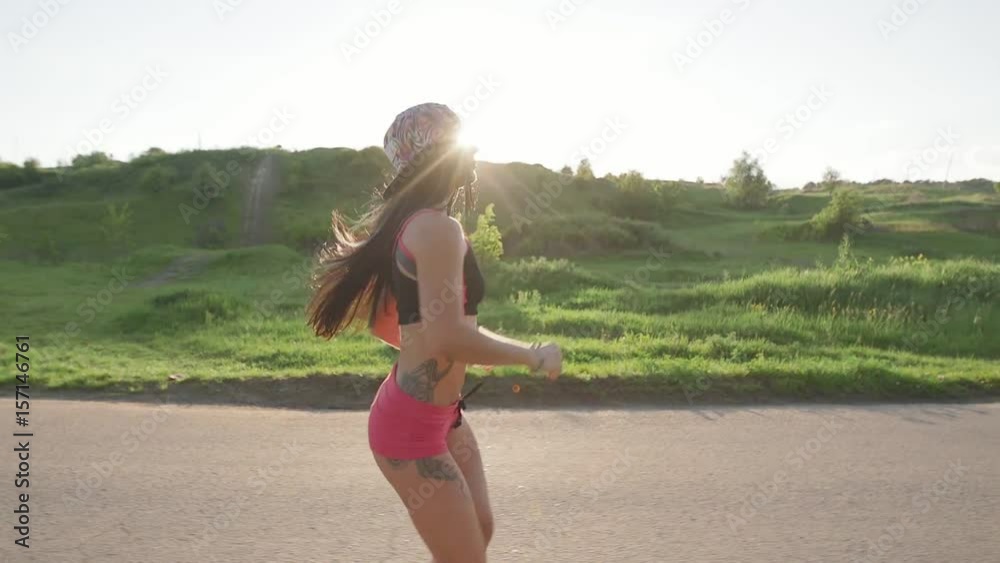 Fitness woman running, beautiful sunset landscape Slow Motion
