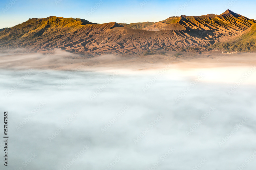 The landscapes of Mount Bromo volcano (Mt.) with daylight toned and sea mist located in Bromo Tengger Semeru National Park, East Java, Indonesia.