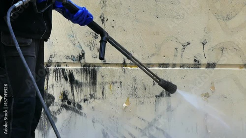 Worker removing graffiti 