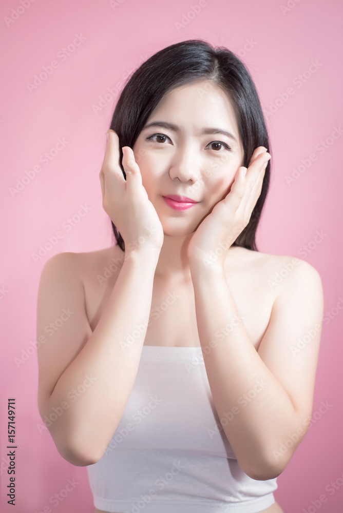 Long hair asian young beautiful woman cross arm and point finger upward isolated over pink background. natural makeup, SPA therapy, skincare, cosmetology and plastic surgery concept. Long hair asian young beautiful woman cross arm and point finger upward isolated over pink background. natural makeup, SPA therapy, skincare, cosmetology and plastic surgery concept.