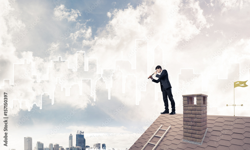 Engineer man standing on roof and looking in spyglass. Mixed med Engineer man standing on roof and looking in spyglass. Mixed med