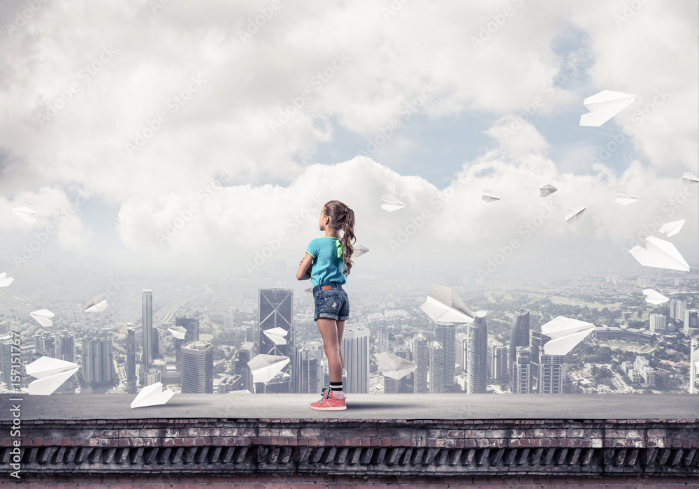 Concept of careless happy childhood with girl looking far away Concept of careless happy childhood with girl looking far away