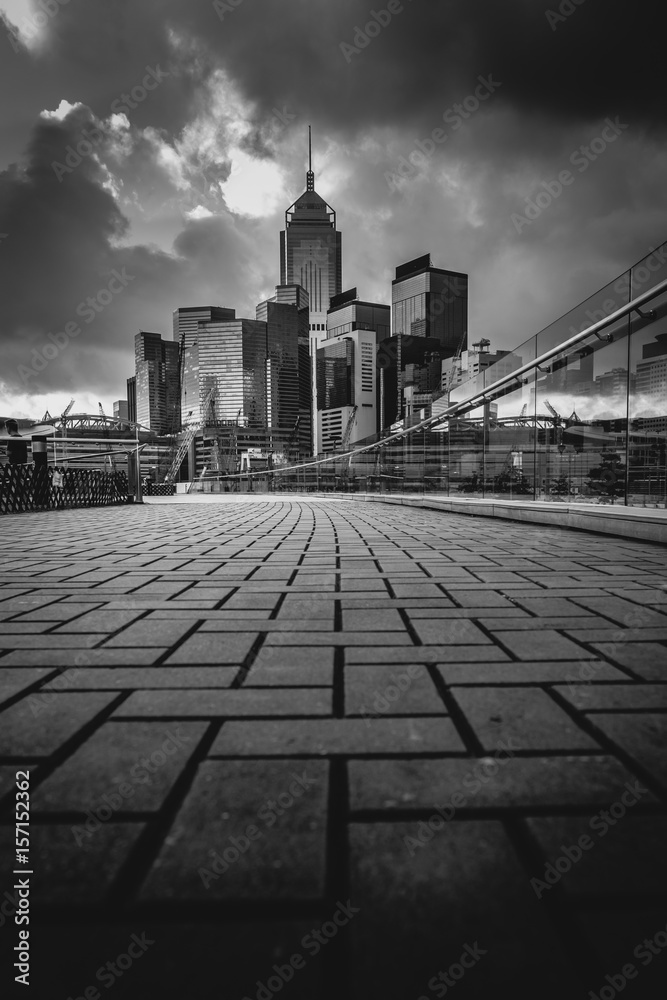 Fototapeta premium Abstract futuristic night cityscape with illuminated skyscrapers.Hong Kong black and white background