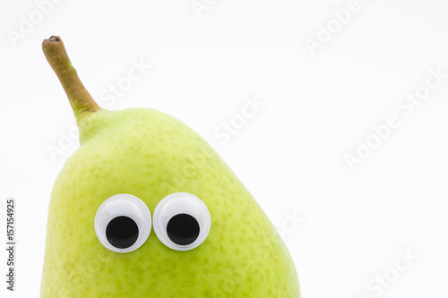 green pear with googly eyes on white background - pear face