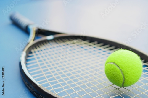 Tennis racket with ball on court