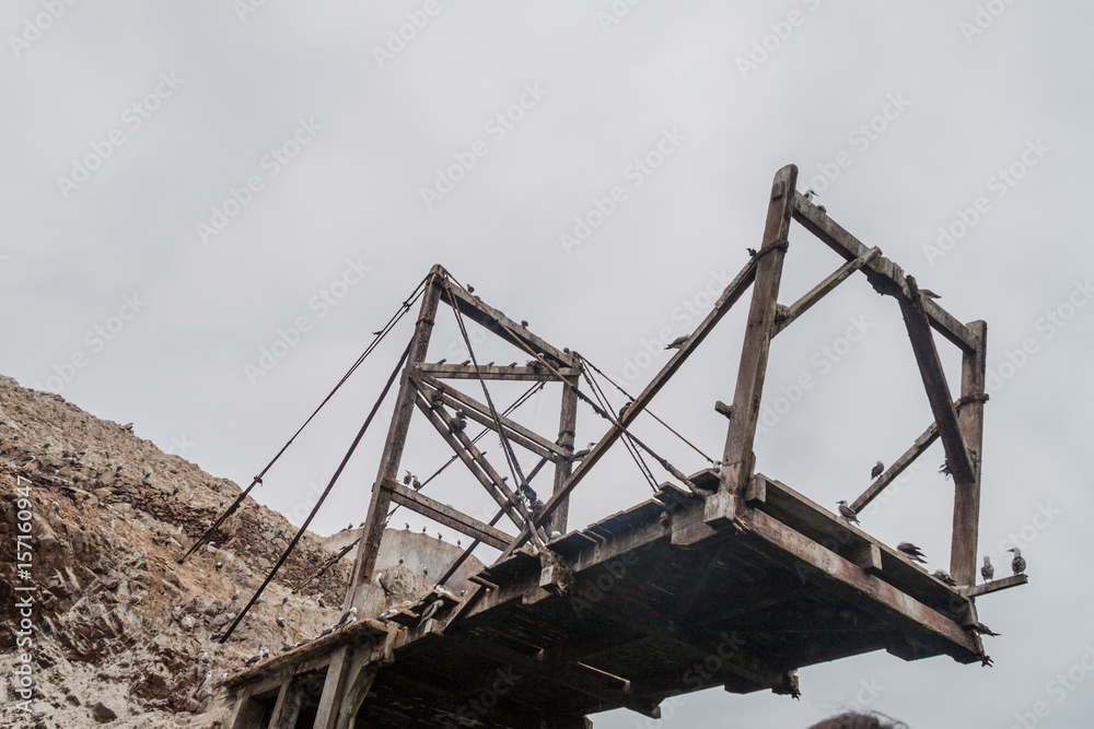 Guano loading post on the rocks of the Ballestas Islands in the Paracas National park, Peru.