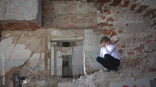 The boy who had the tragedy, he alone in the ruined building after the war, lost, fear, loneliness, threat, loss and grief