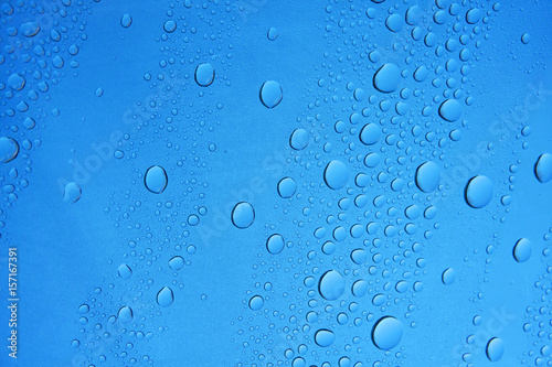 raindrop on window glass against blue sky