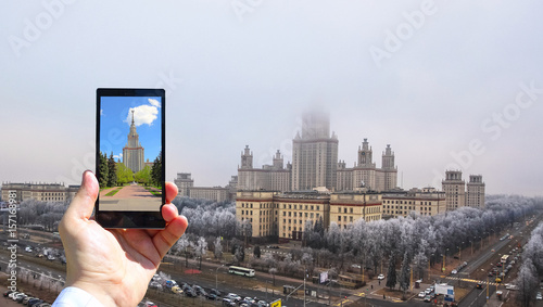 Conceptual view of large diversity of Moscow state university viewed through smart phone screen in human hand