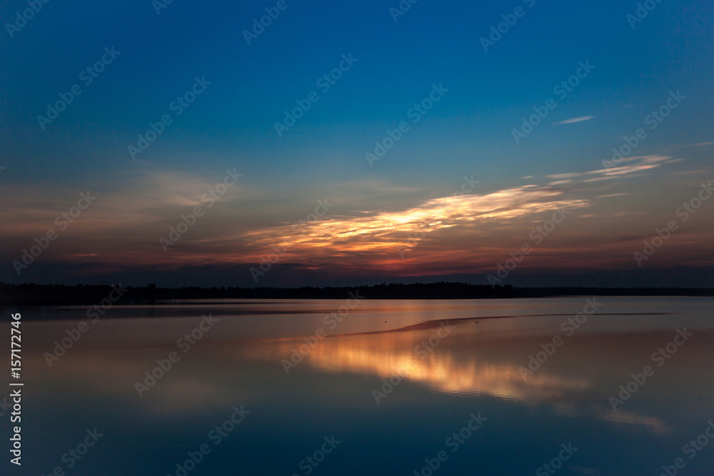Beautiful stormy sunset. Fiery orange sunset sky.